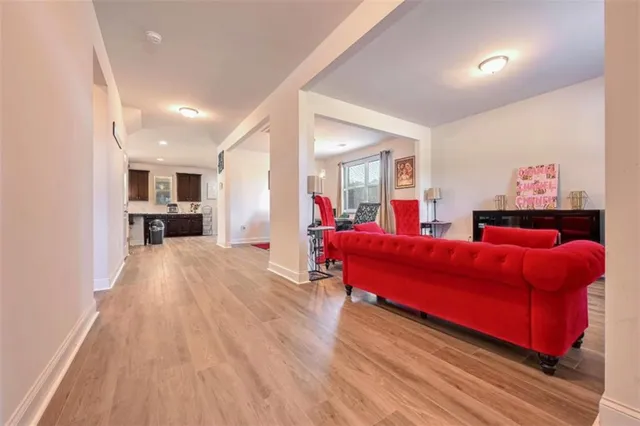 a living room with furniture and a wooden floor