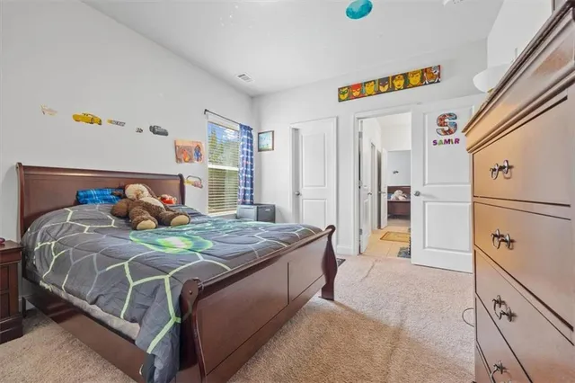 a bed room with a bed and a dresser