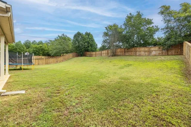a view of a yard with a house in the background