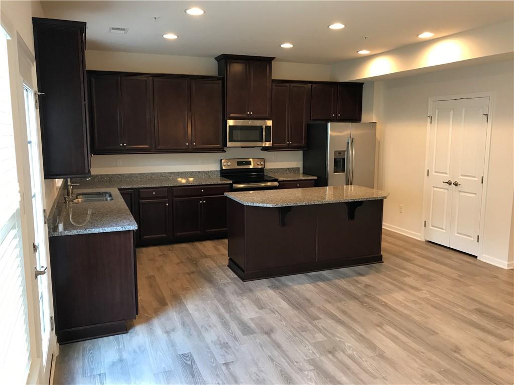 2004 Pointe View Drive Mars, PA 16046 - Photo 5 of 23 a kitchen with stainless steel appliances granite countertop wooden cabinets a refrigerator a sink and a stove