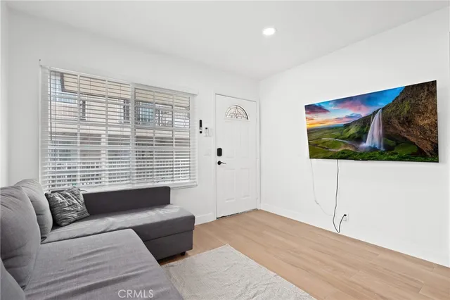 a view of front door with wooden floor and stairs