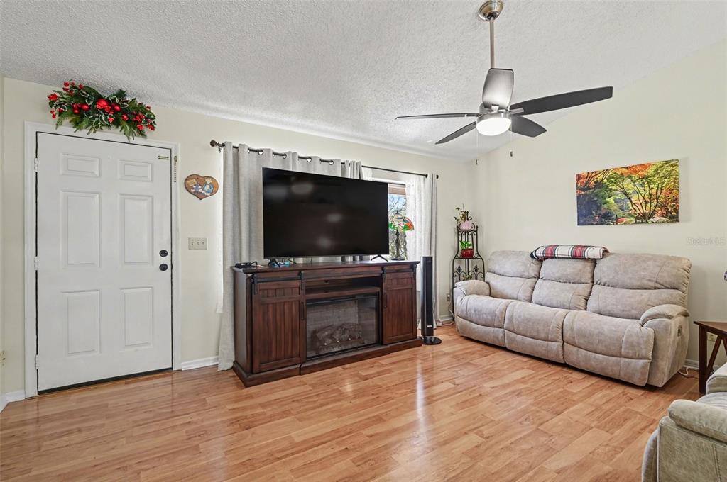 12435 Orangewood Circle Tavares, FL 32778 - Photo 8 of 30 a living room with furniture and a flat screen tv