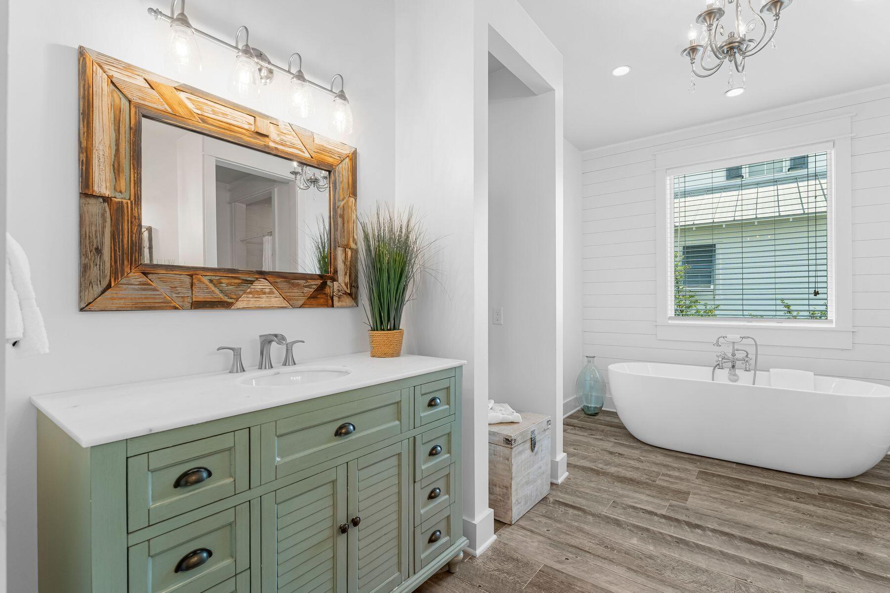 44 The Greenway Loop Inlet Beach, FL 32461 - Photo 28 of 61 a spacious bathroom with double vanity a mirror a bathtub and a window
