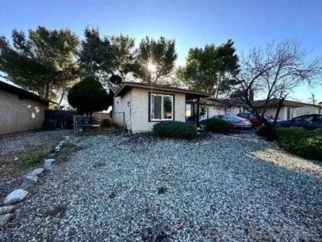 a view of a house with a yard and a garden