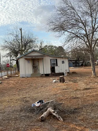 a view of a house with backyard space and a tree