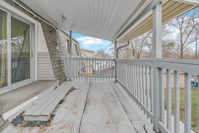 a view of a balcony with wooden floor