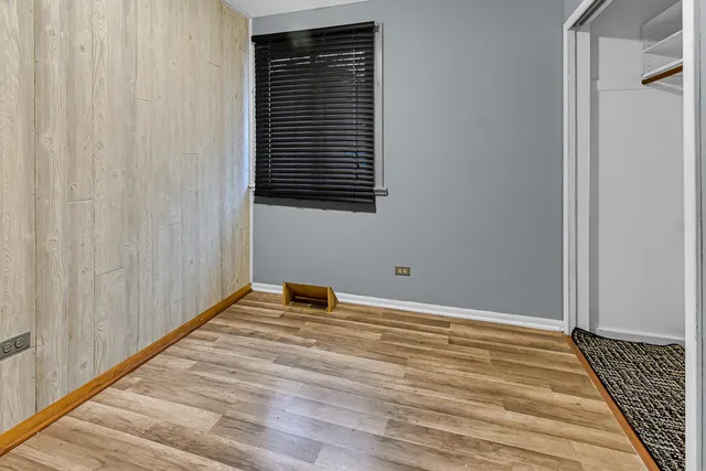a view of a room with wooden floor and a window