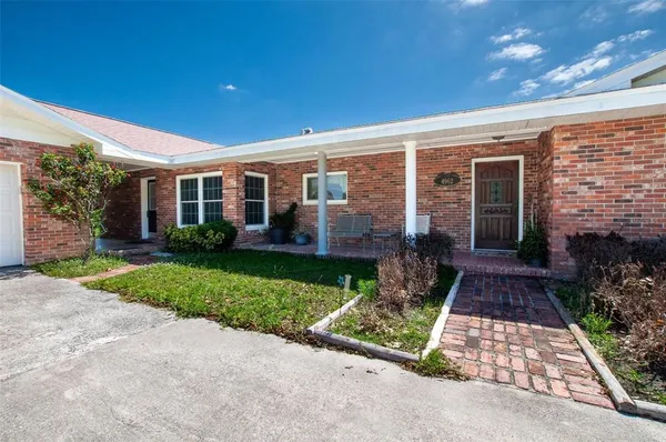 a view of a field with grass and trees
