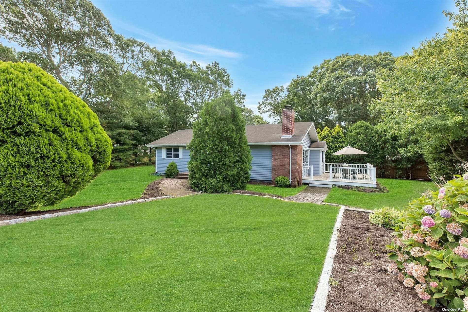 45 West Donellan Road Hampton Bays, NY 11946 - Photo 1 of 1 a front view of a house with a yard