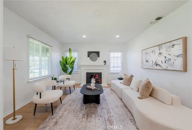 a living room with furniture fireplace and window