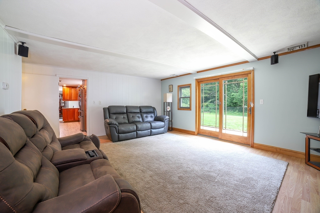 40 Old Stage Road Chelmsford, MA 01824 - Photo 12 of 34 a living room with couches and a flat screen tv