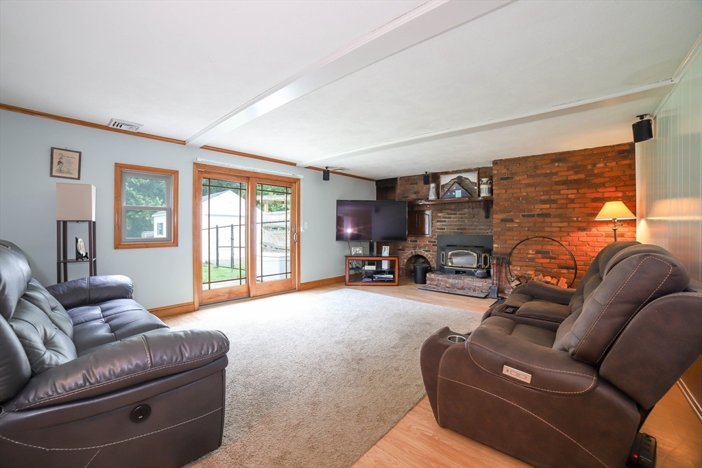 40 Old Stage Road Chelmsford, MA 01824 - Photo 13 of 34 a living room with furniture a flat screen tv and a window