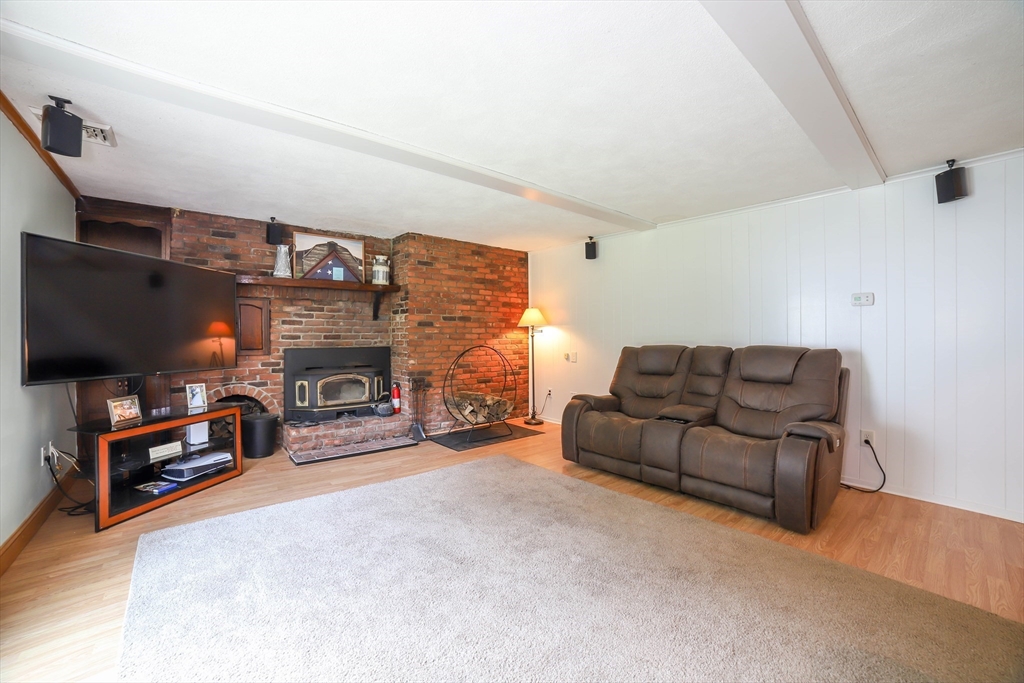 40 Old Stage Road Chelmsford, MA 01824 - Photo 14 of 34 a living room with furniture and a flat screen tv