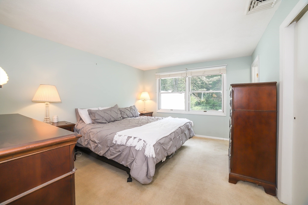 40 Old Stage Road Chelmsford, MA 01824 - Photo 15 of 34 a bedroom with a bed and a lamp