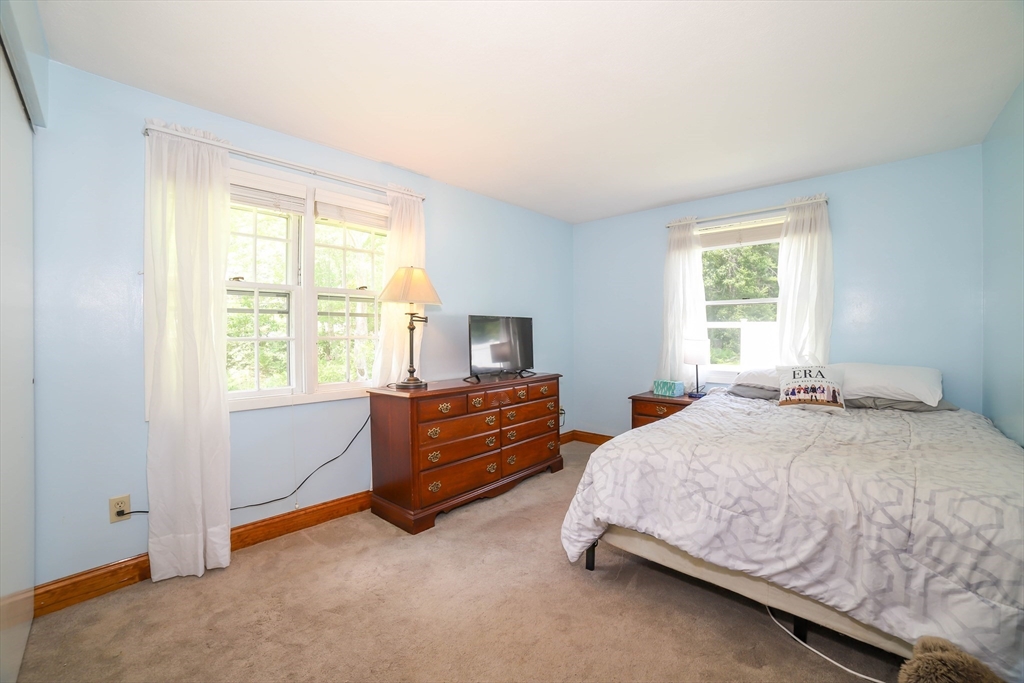 40 Old Stage Road Chelmsford, MA 01824 - Photo 17 of 34 a bedroom with a bed and windows