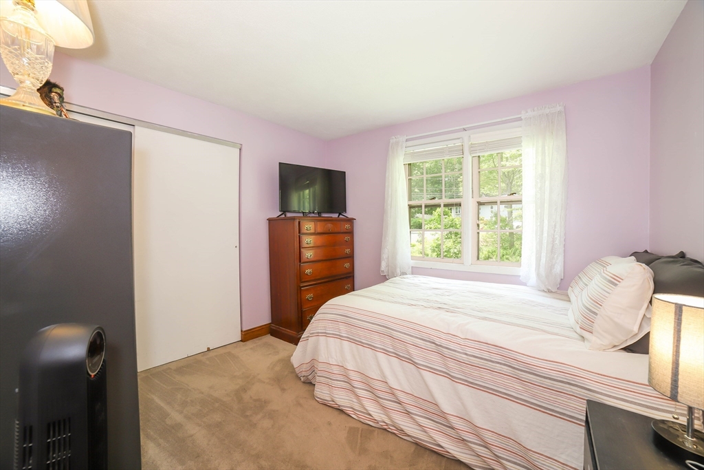 40 Old Stage Road Chelmsford, MA 01824 - Photo 18 of 34 a bedroom with a bed and a television