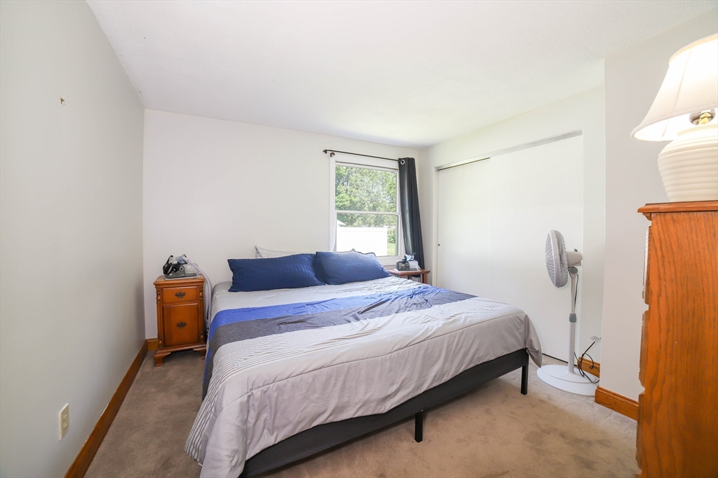 40 Old Stage Road Chelmsford, MA 01824 - Photo 19 of 34 a bedroom with a bed and wooden floor