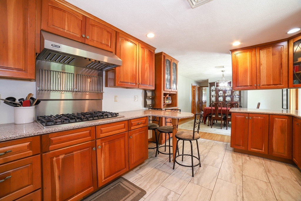 40 Old Stage Road Chelmsford, MA 01824 - Photo 2 of 34 a kitchen with stainless steel appliances granite countertop a stove a sink dishwasher and cabinets with wooden floor