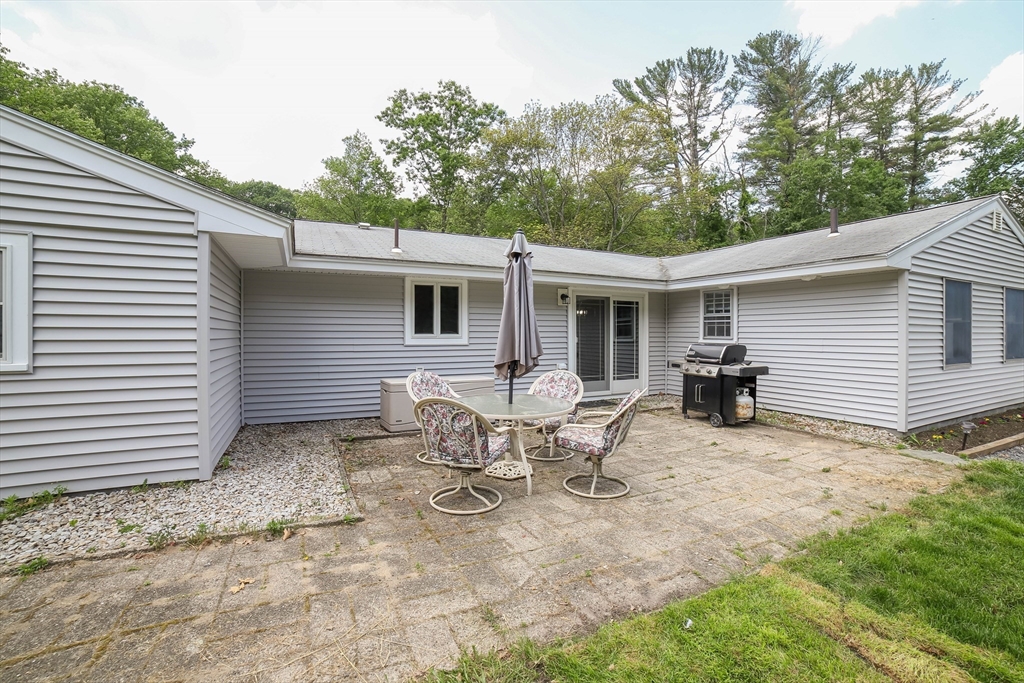 40 Old Stage Road Chelmsford, MA 01824 - Photo 30 of 34 a view of a white house with a small yard and a large tree