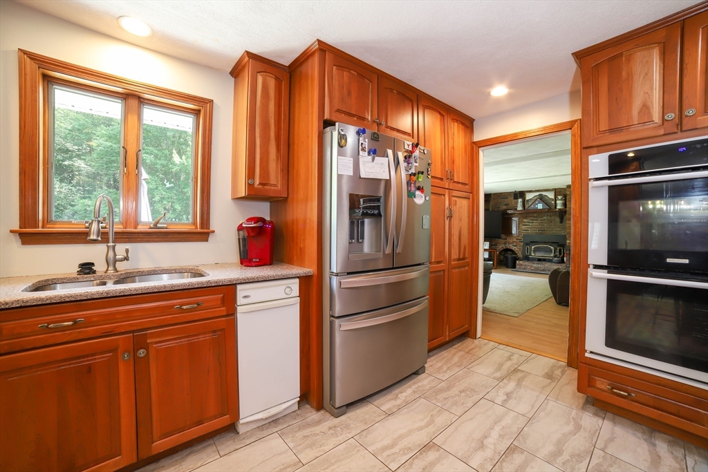40 Old Stage Road Chelmsford, MA 01824 - Photo 6 of 34 a kitchen with stainless steel appliances a sink cabinets and a window