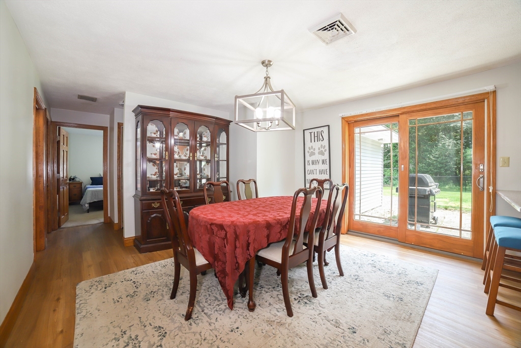40 Old Stage Road Chelmsford, MA 01824 - Photo 9 of 34 a dining room with furniture window and wooden floor