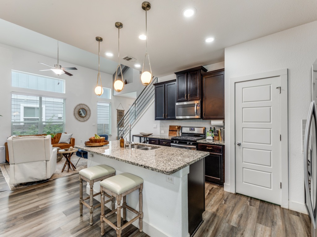 2204 Montague Street Austin, TX 78741 - Photo 25 of 25 a kitchen with a sink a stove cabinets and wooden floor