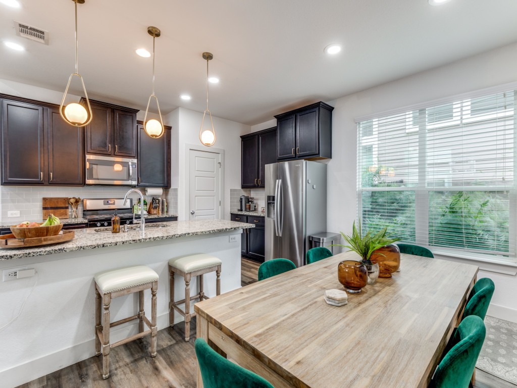 2204 Montague Street Austin, TX 78741 - Photo 16 of 25 a kitchen with sink a refrigerator and chairs