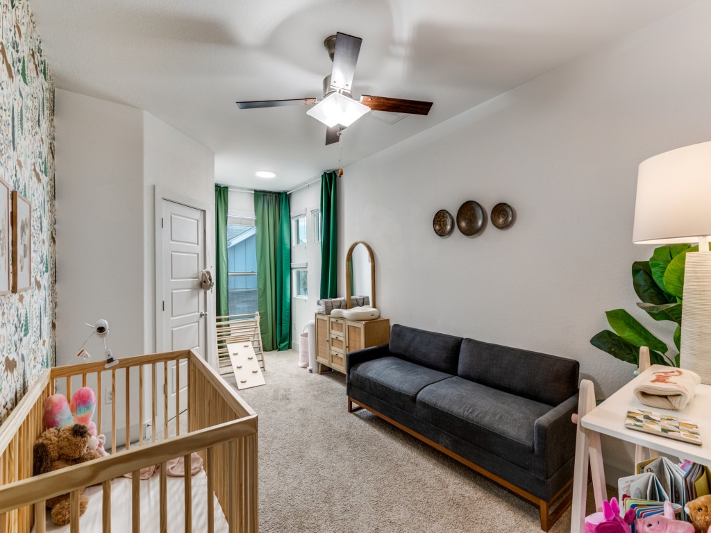 2204 Montague Street Austin, TX 78741 - Photo 19 of 25 a living room with furniture and a baby crib
