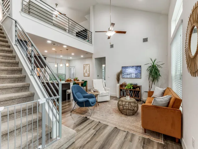 a living room with furniture and a chandelier