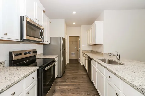 a kitchen with a sink stove and refrigerator