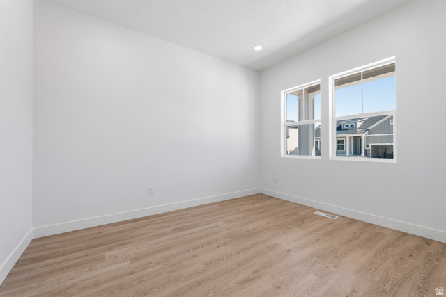 58 South Crimson Way, Unit 306 Mapleton, UT 84664 - Photo 5 of 24 Bright interior room featuring wood-finish flooring, white baseboards, and clean white walls