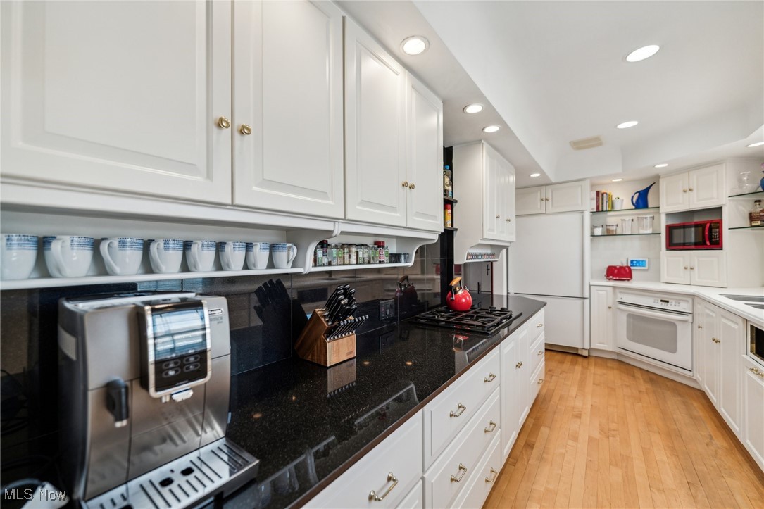 3320 Avalon Road Cleveland, OH 44120 - Photo 8 of 28 Kitchen featuring
white cabinetry, counters, cabinets, appliances , and hardwood floors