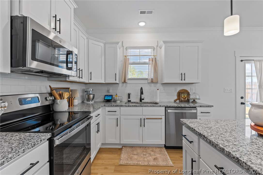 278 Slade Corner Road Raeford, NC 28376 - Photo 16 of 39 a kitchen with stainless steel appliances granite countertop a sink stove and microwave