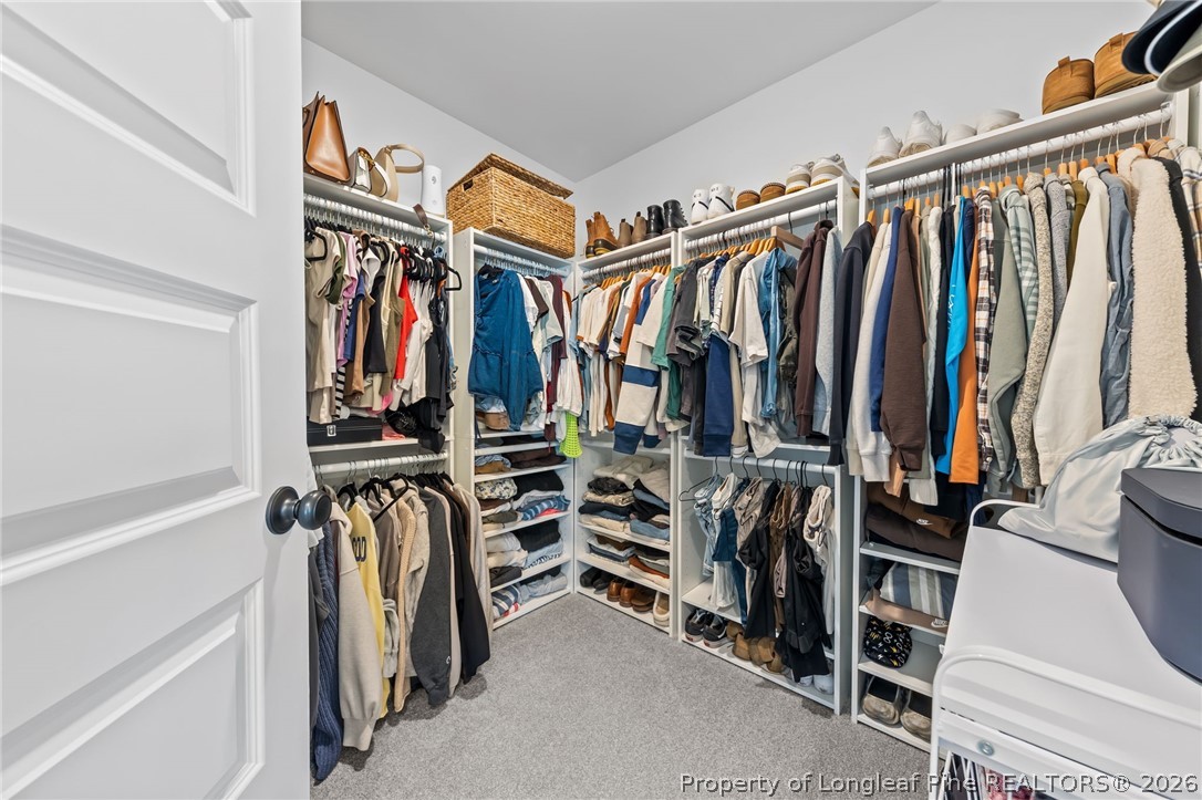 278 Slade Corner Road Raeford, NC 28376 - Photo 23 of 39 a view of walk in closet with clothes and shoes