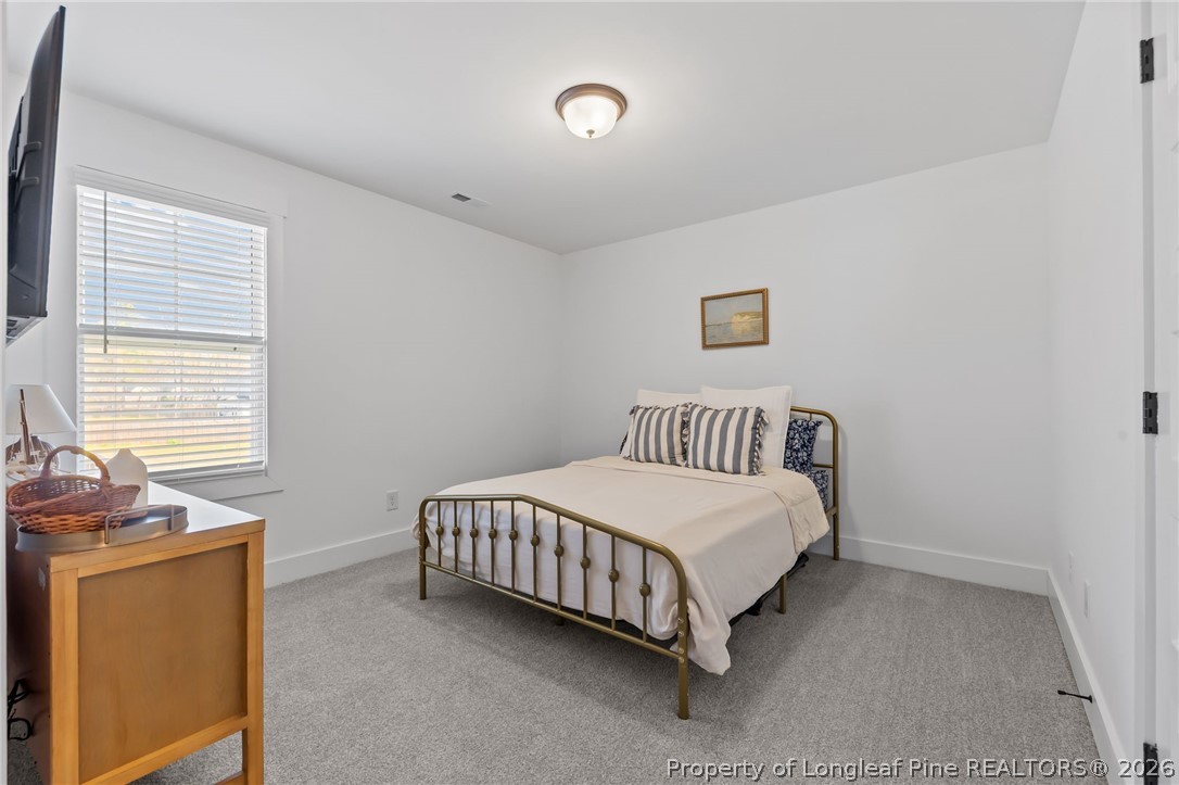 278 Slade Corner Road Raeford, NC 28376 - Photo 27 of 39 a bedroom with a bed and a window