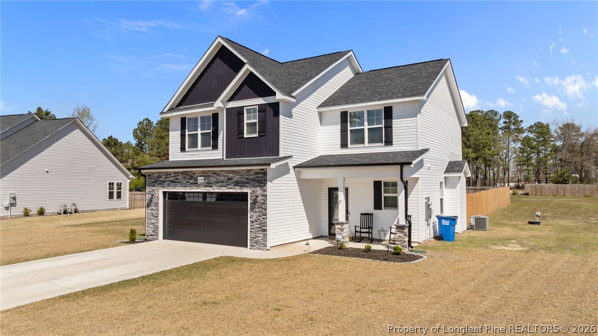 278 Slade Corner Road Raeford, NC 28376 - Photo 3 of 39 a view of a house with a yard and garage