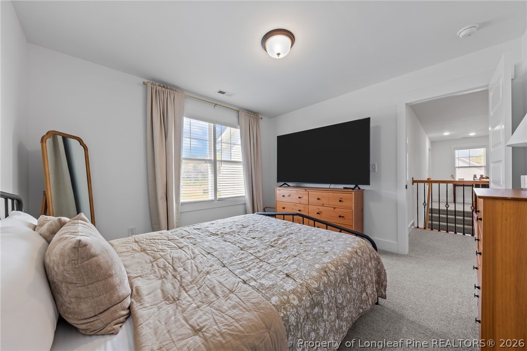 278 Slade Corner Road Raeford, NC 28376 - Photo 31 of 39 a bedroom with a bed and a flat screen tv