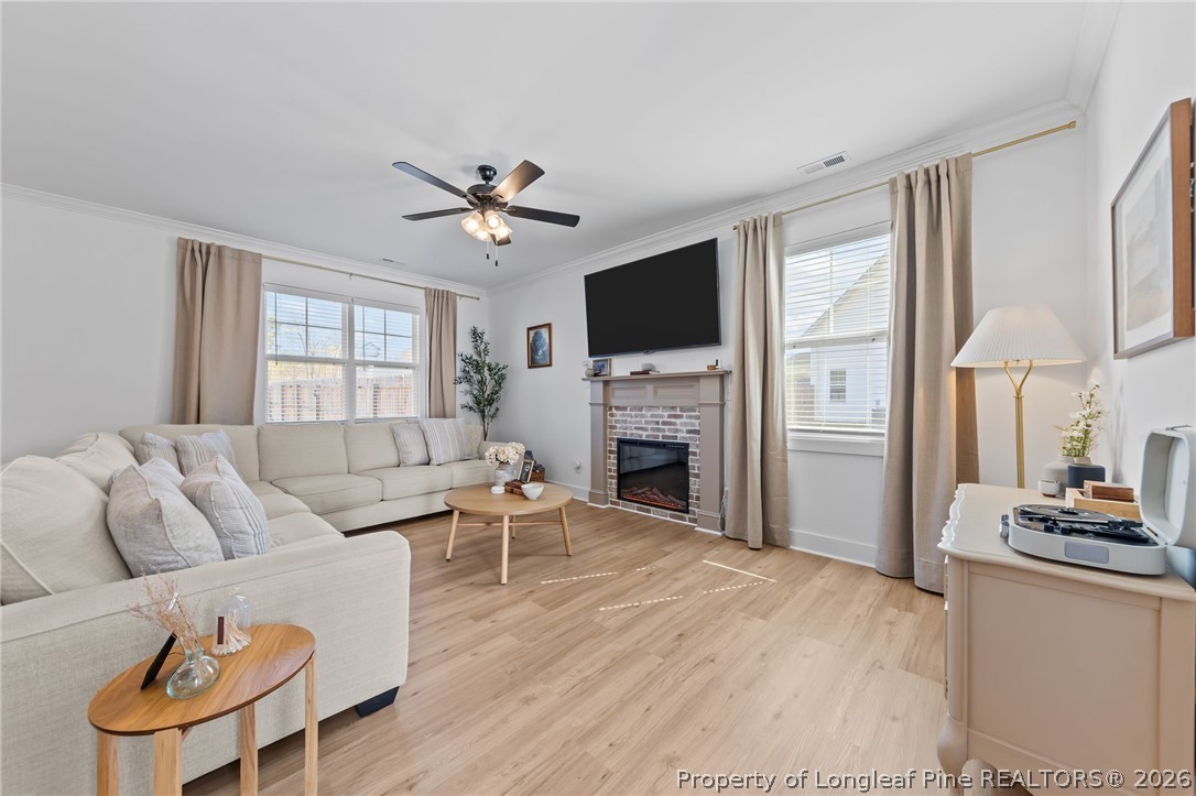278 Slade Corner Road Raeford, NC 28376 - Photo 6 of 39 a living room with furniture a fireplace and a flat screen tv
