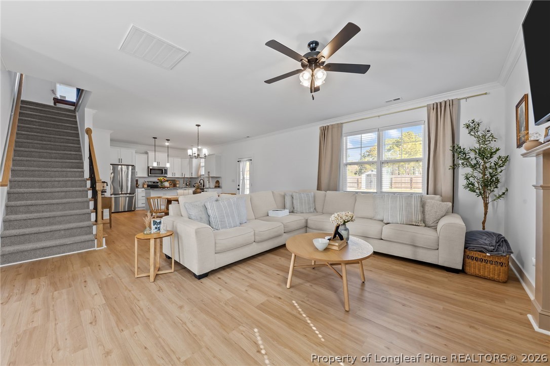 278 Slade Corner Road Raeford, NC 28376 - Photo 7 of 39 a living room with furniture and a wooden floor