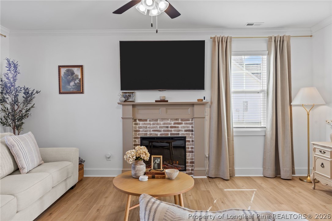 278 Slade Corner Road Raeford, NC 28376 - Photo 8 of 39 a living room with furniture a flat screen tv and a fireplace