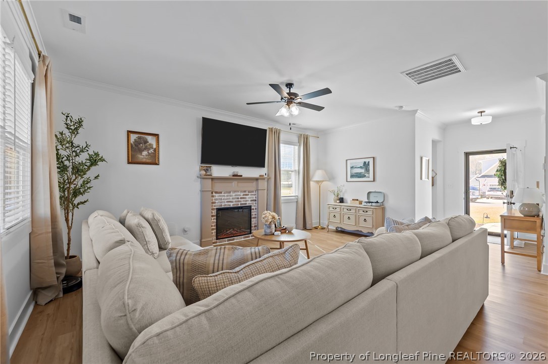 278 Slade Corner Road Raeford, NC 28376 - Photo 9 of 39 a living room with furniture a fireplace and a flat screen tv