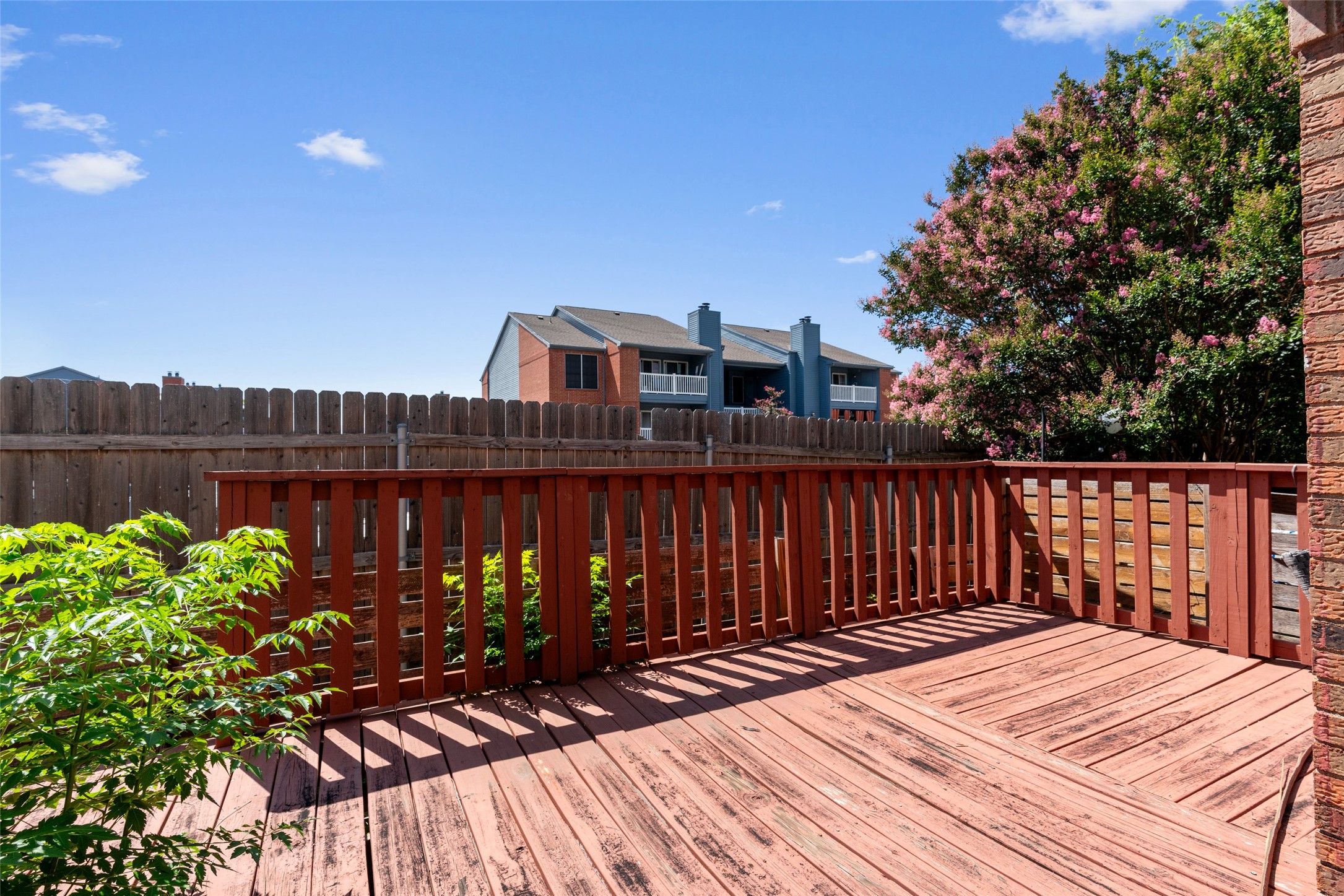 2018 West Rundberg Lane, Unit 16D Austin, TX 78758 - Photo 17 of 18 A spacious wooden deck provides an outdoor retreat with a privacy fence