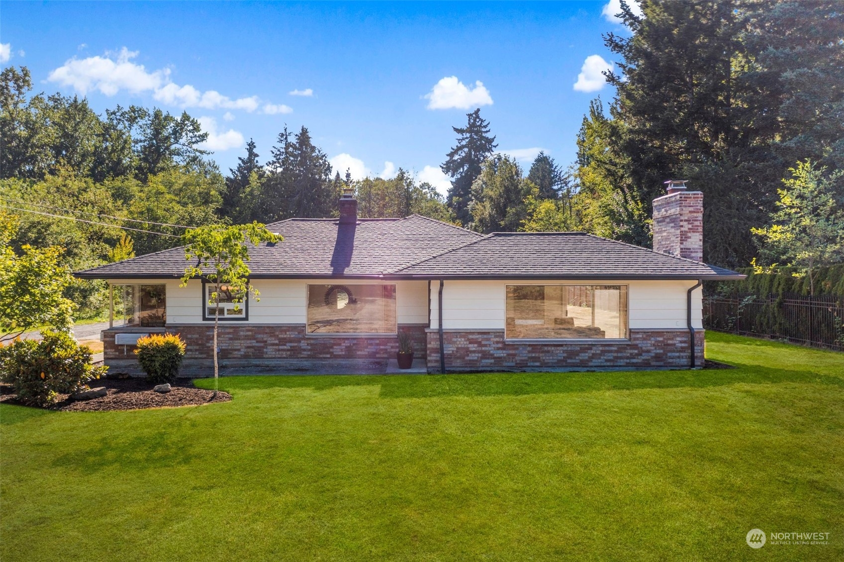 a front view of a house with a garden