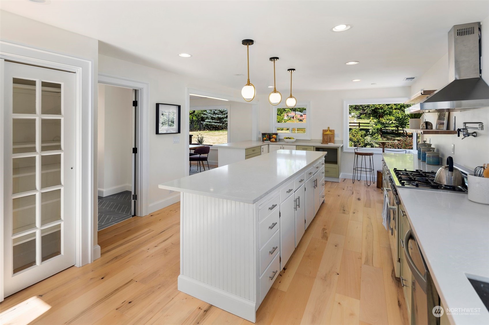 24124 7th Avenue Southeast Bothell, WA 98021 - Photo 21 of 40 a large kitchen with kitchen island a large counter top space a sink stainless steel appliances and cabinets