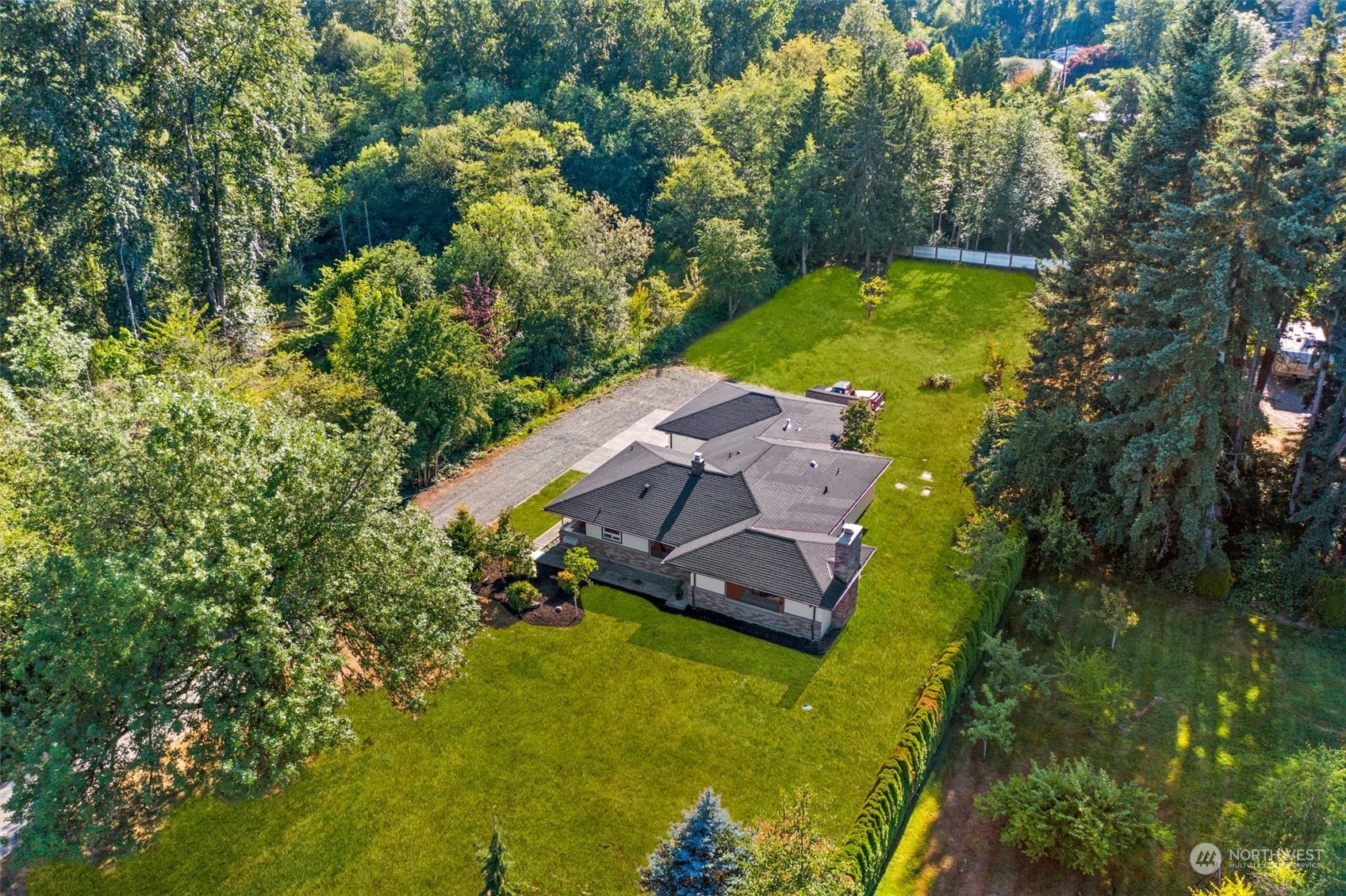 24124 7th Avenue Southeast Bothell, WA 98021 - Photo 4 of 40 an aerial view of a house with a swimming pool a yard and lake view