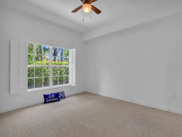 an empty room with a window and a fireplace