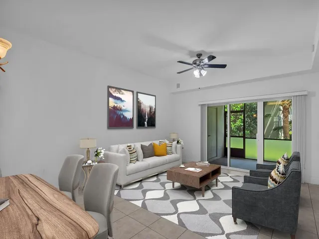 a living room with furniture and floor to ceiling windows