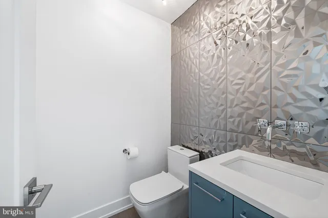 a kitchen with cabinets and chairs