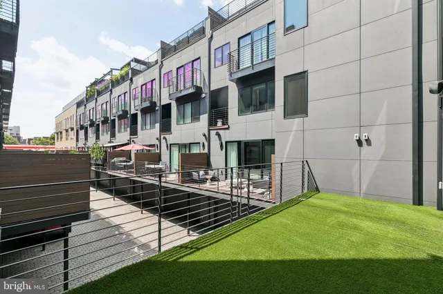 a bedroom with a bed a couch and dresser