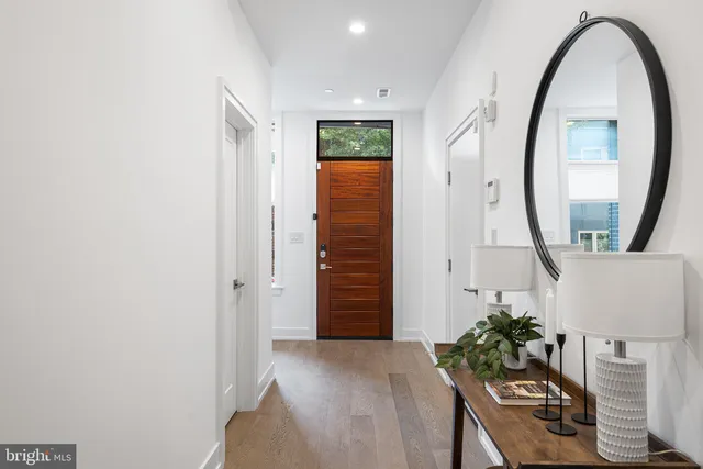 a view of hallway with wooden floor